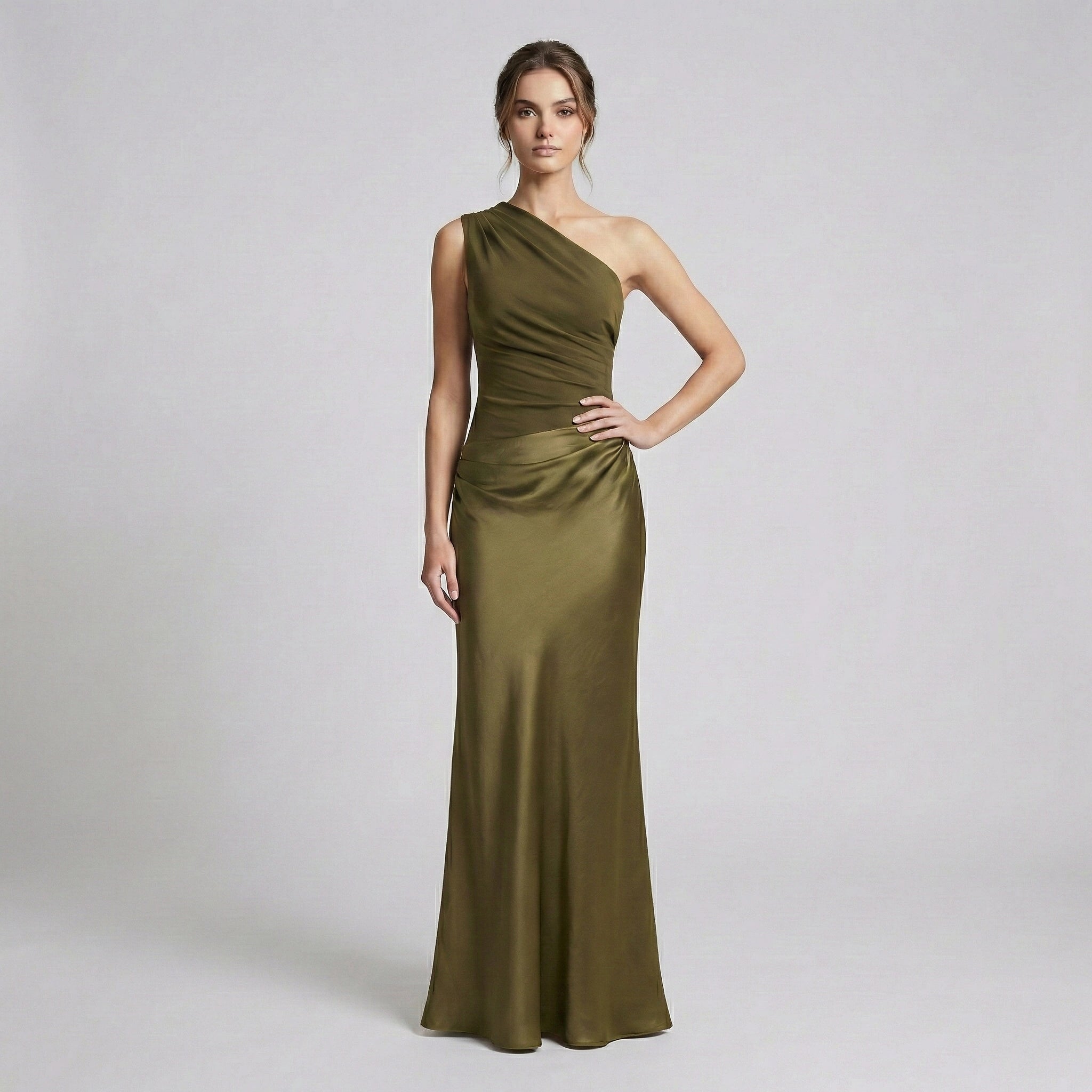 Woman wearing a green one-shoulder dress on a white background
