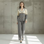 Woman wearing a gray and beige suit on a gray background