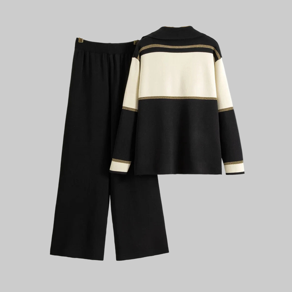 Black and beige outfit with wide-leg pants and a matching top on hangers against a gray background.