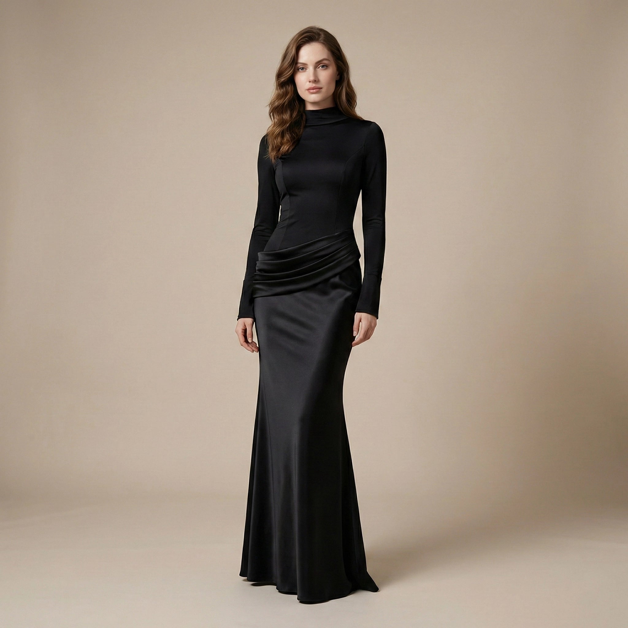 Woman wearing a black evening gown against a beige background