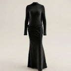 Black long-sleeve dress on a beige background