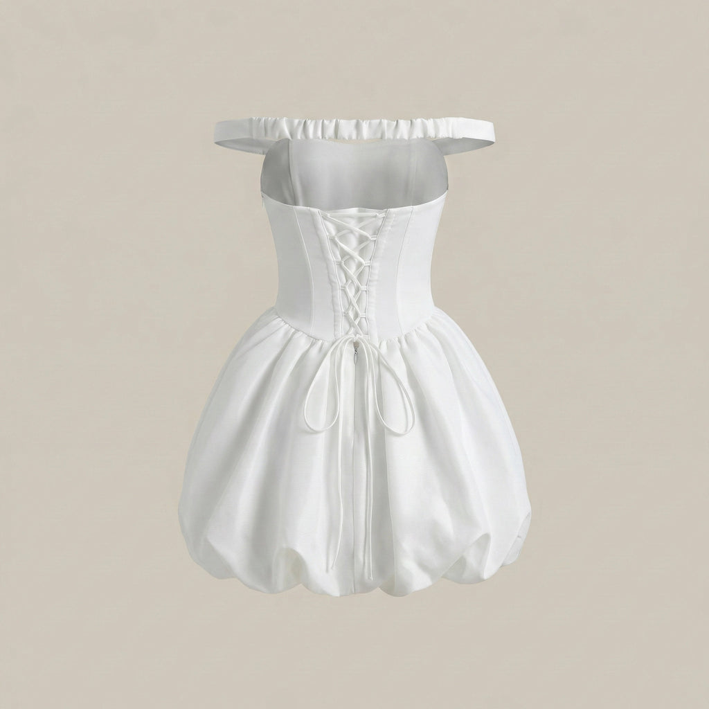 White off-shoulder dress on a beige background