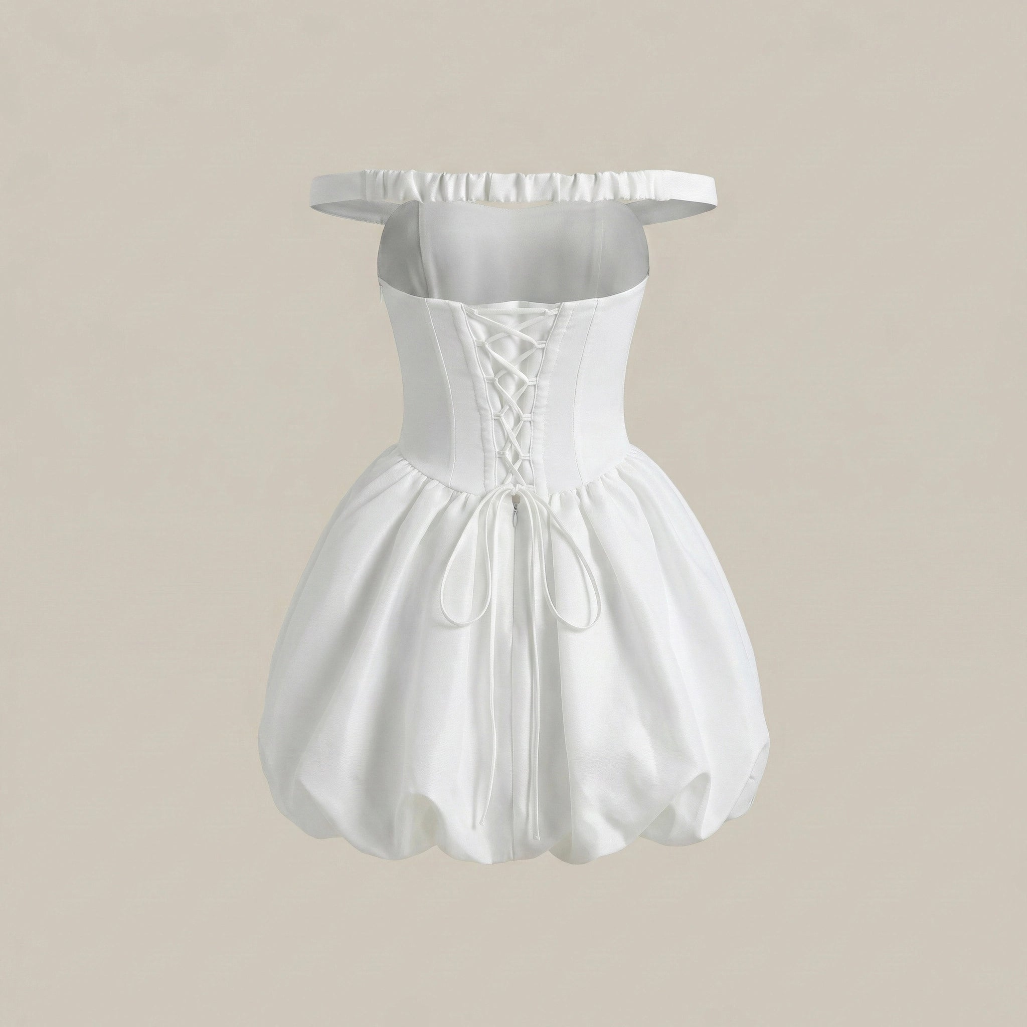 White off-shoulder dress on a beige background