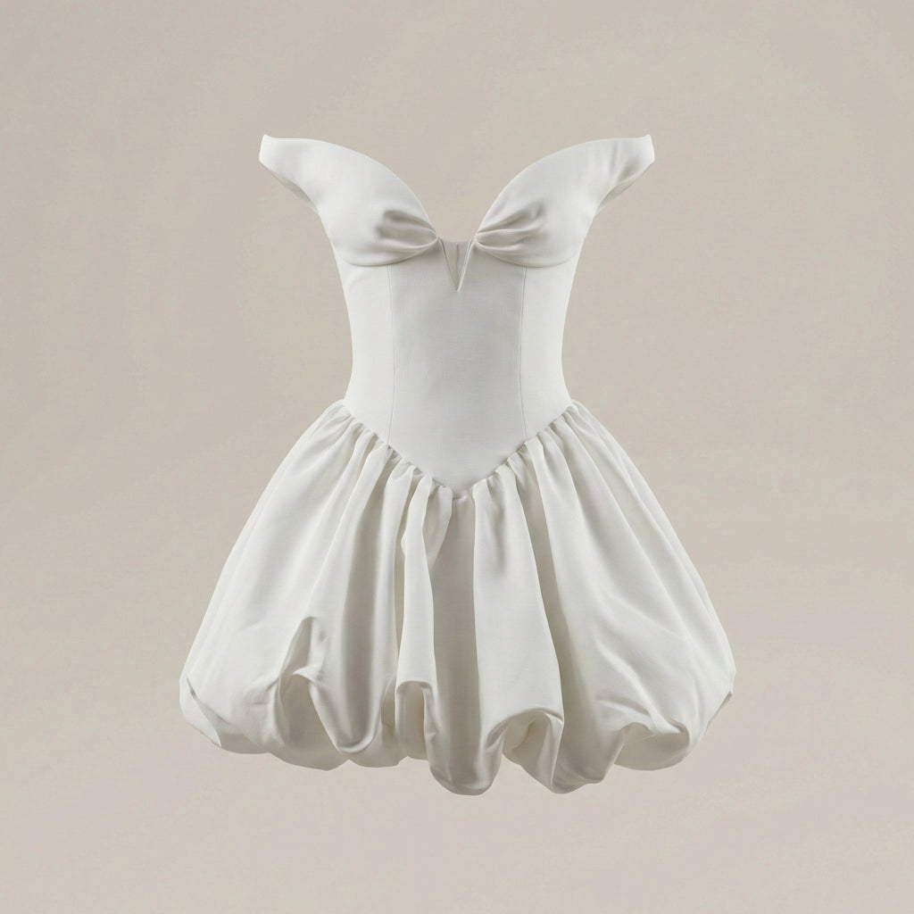 White dress with bow detail on a beige background