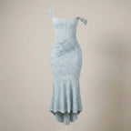 Light blue dress with ruched details on a beige background