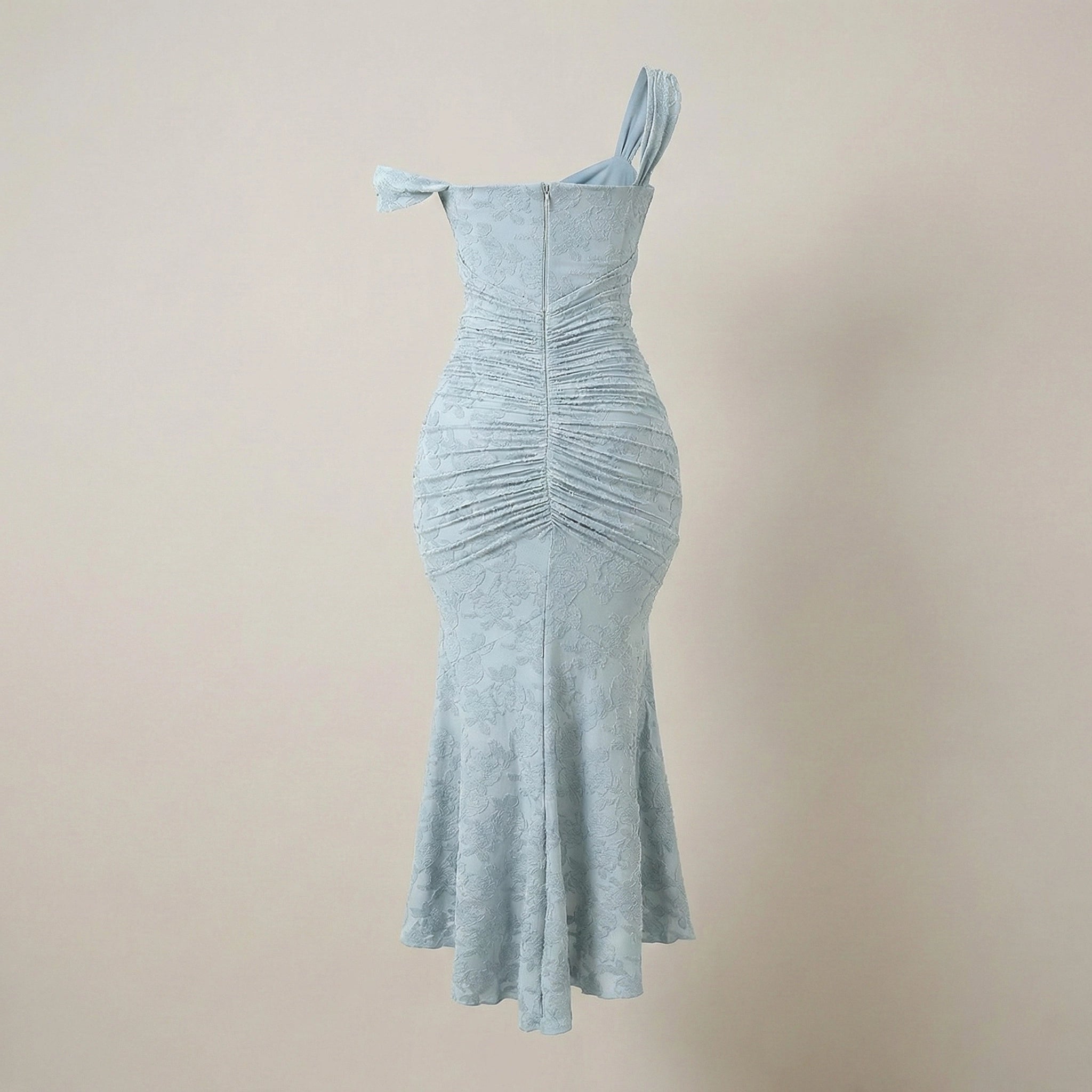 Light blue one-shoulder dress on a beige background