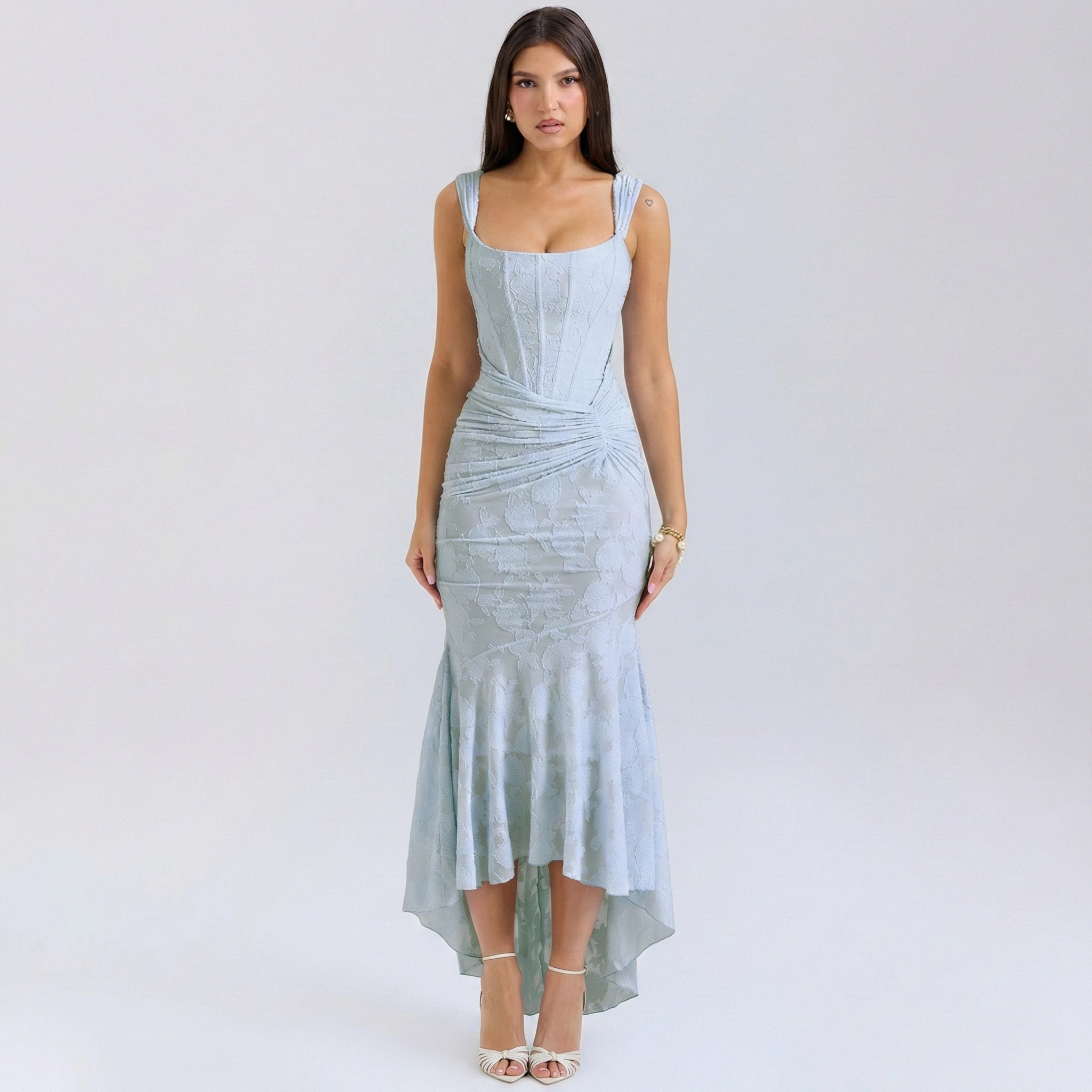 Woman wearing a light blue dress on a white background