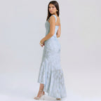 Woman wearing a light blue dress with cut-out design on a white background