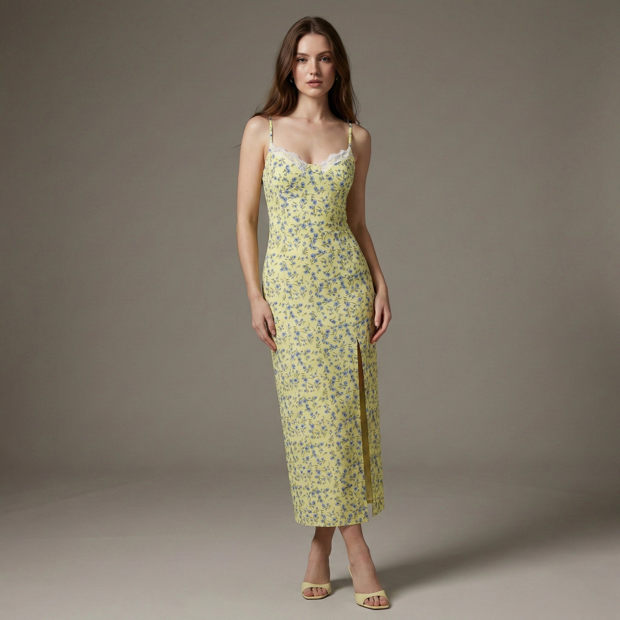 Woman wearing a yellow floral dress against a gray background