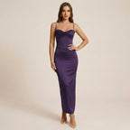 Woman wearing a purple evening gown on a beige background