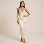 Woman wearing a white strapless dress against a beige background