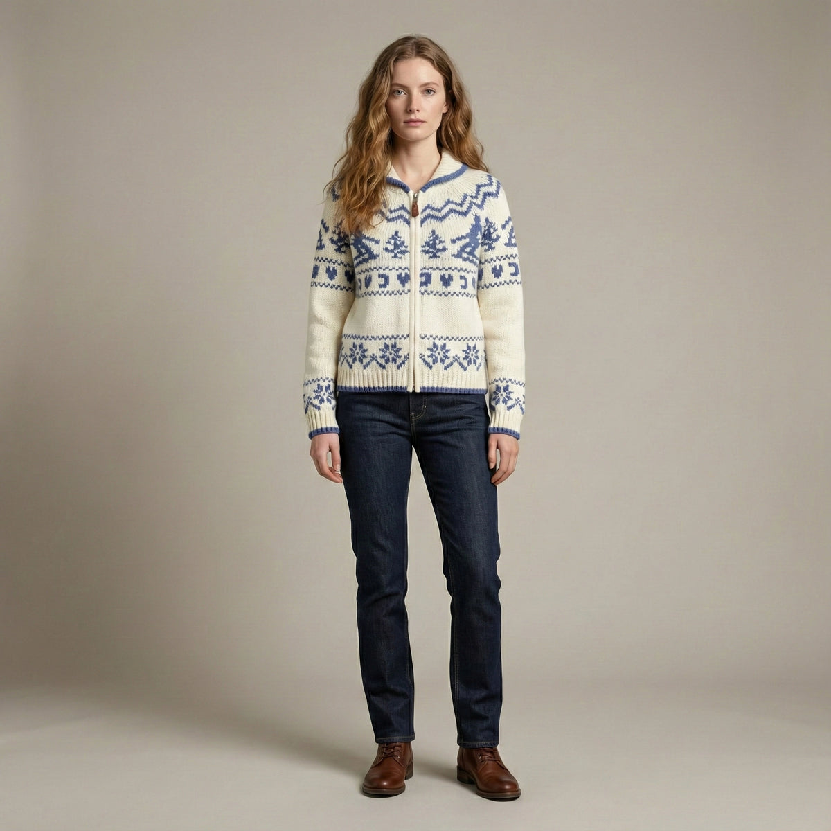 Woman wearing a patterned sweater and dark jeans against a plain background
