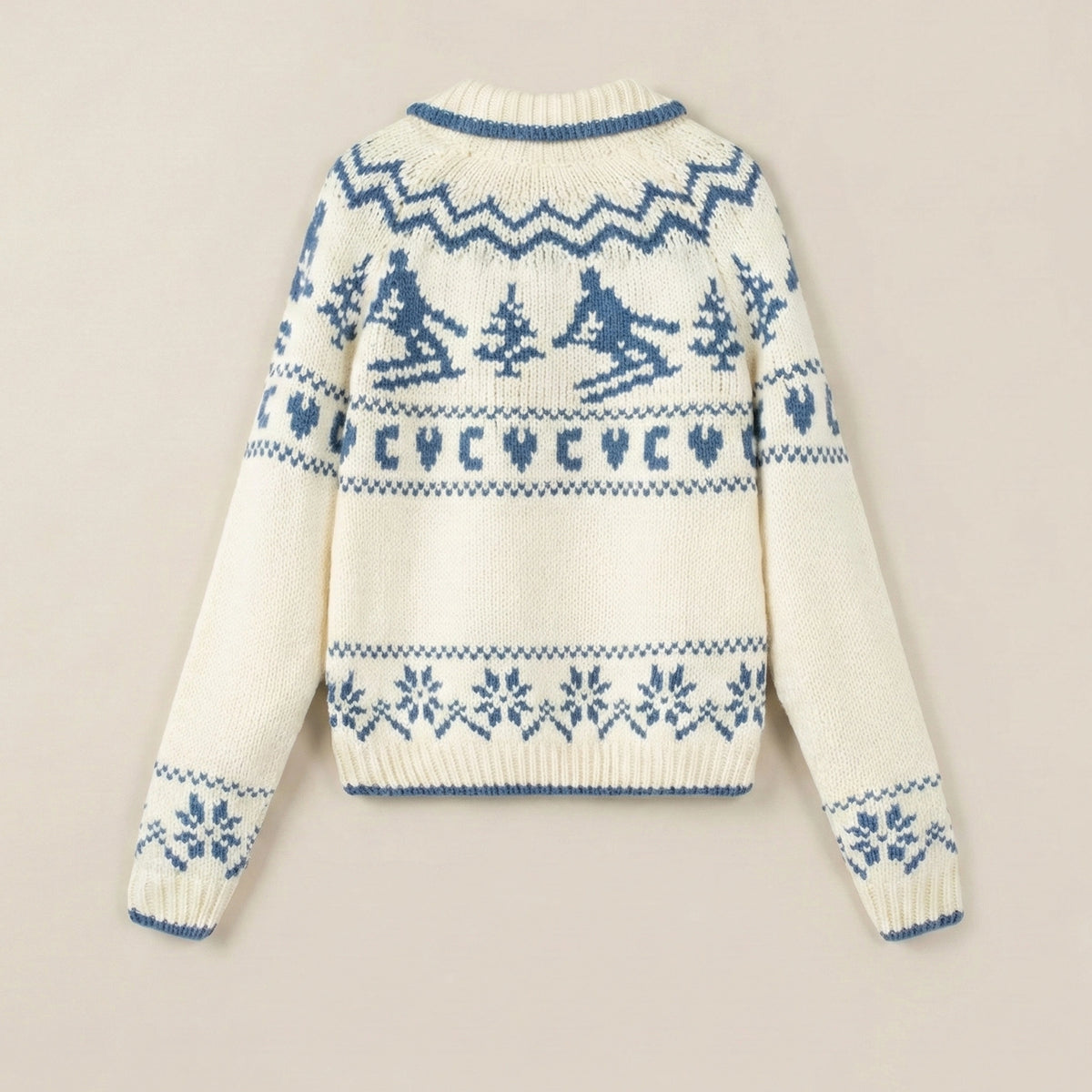 White sweater with blue pattern on a beige background
