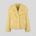 Yellow fluffy jacket on a light gray background