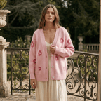 Woman wearing a pink floral cardigan in an outdoor setting