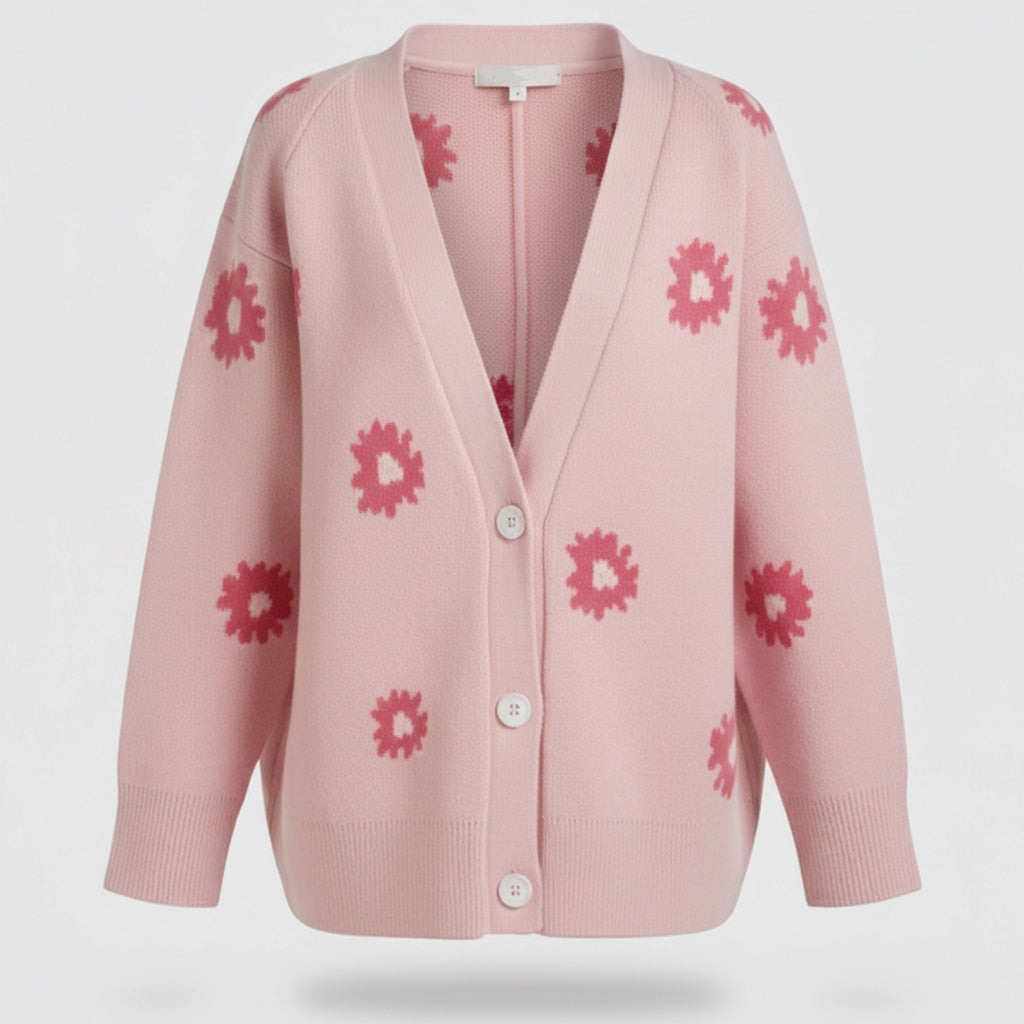 Pink cardigan with floral patterns on a light gray background