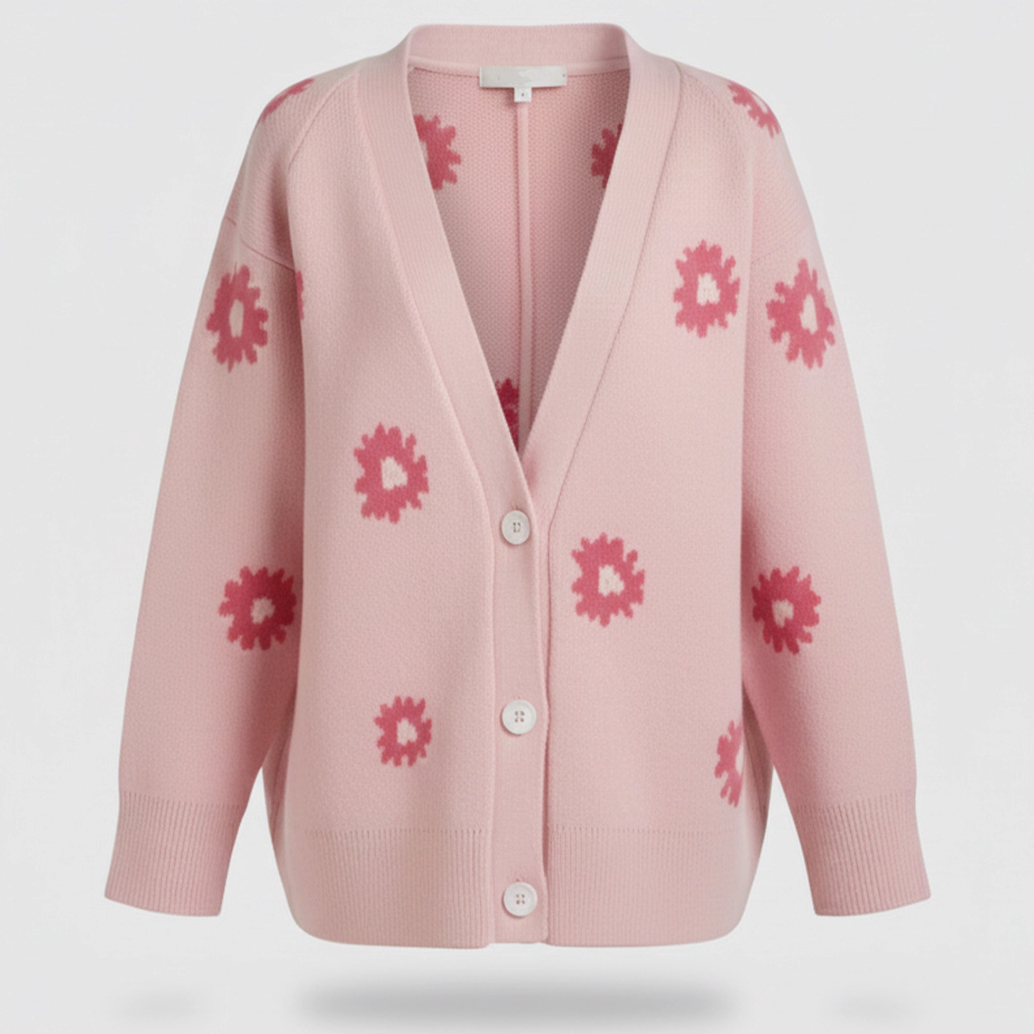 Pink cardigan with floral patterns on a light gray background
