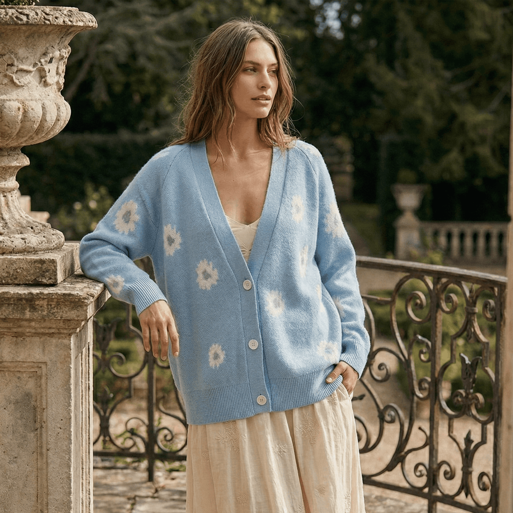 Woman wearing a light blue cardigan with floral patterns in an outdoor setting