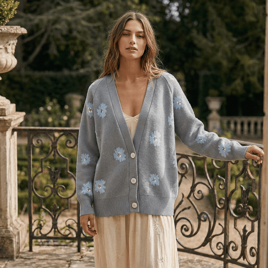 Woman wearing a gray cardigan with floral patterns in an outdoor setting