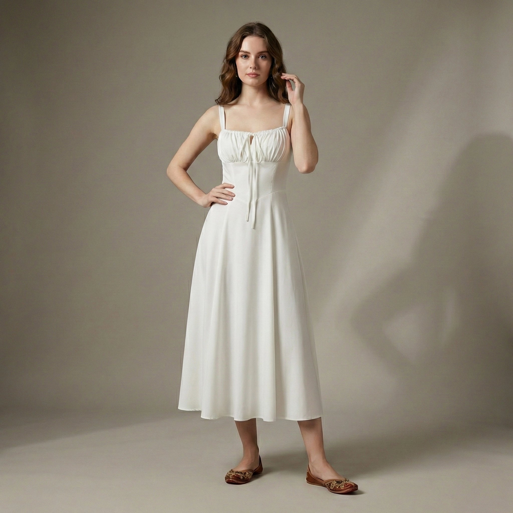 Woman wearing a white dress against a neutral background