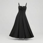 Black dress with thin straps on a light gray background