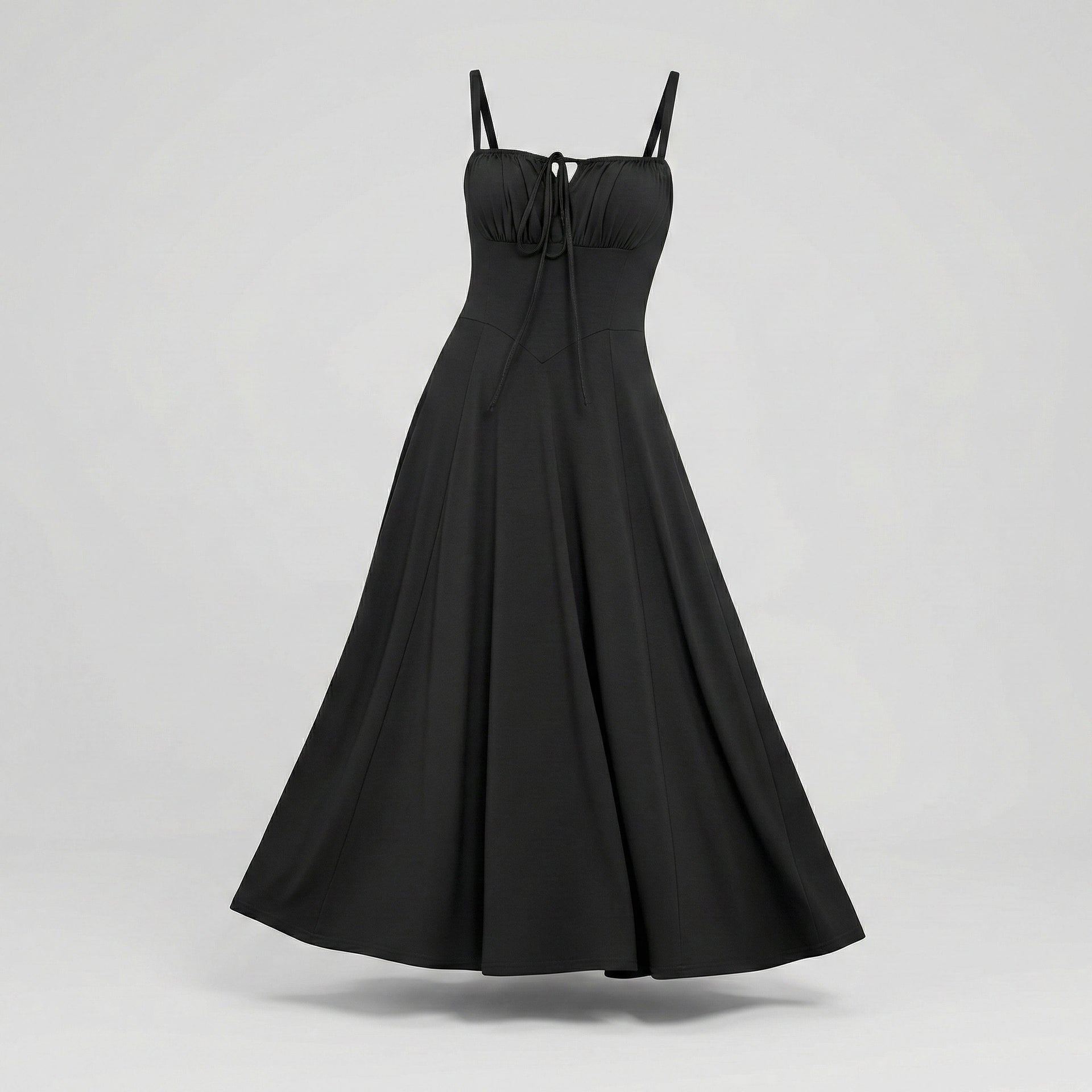 Black dress with thin straps on a light gray background