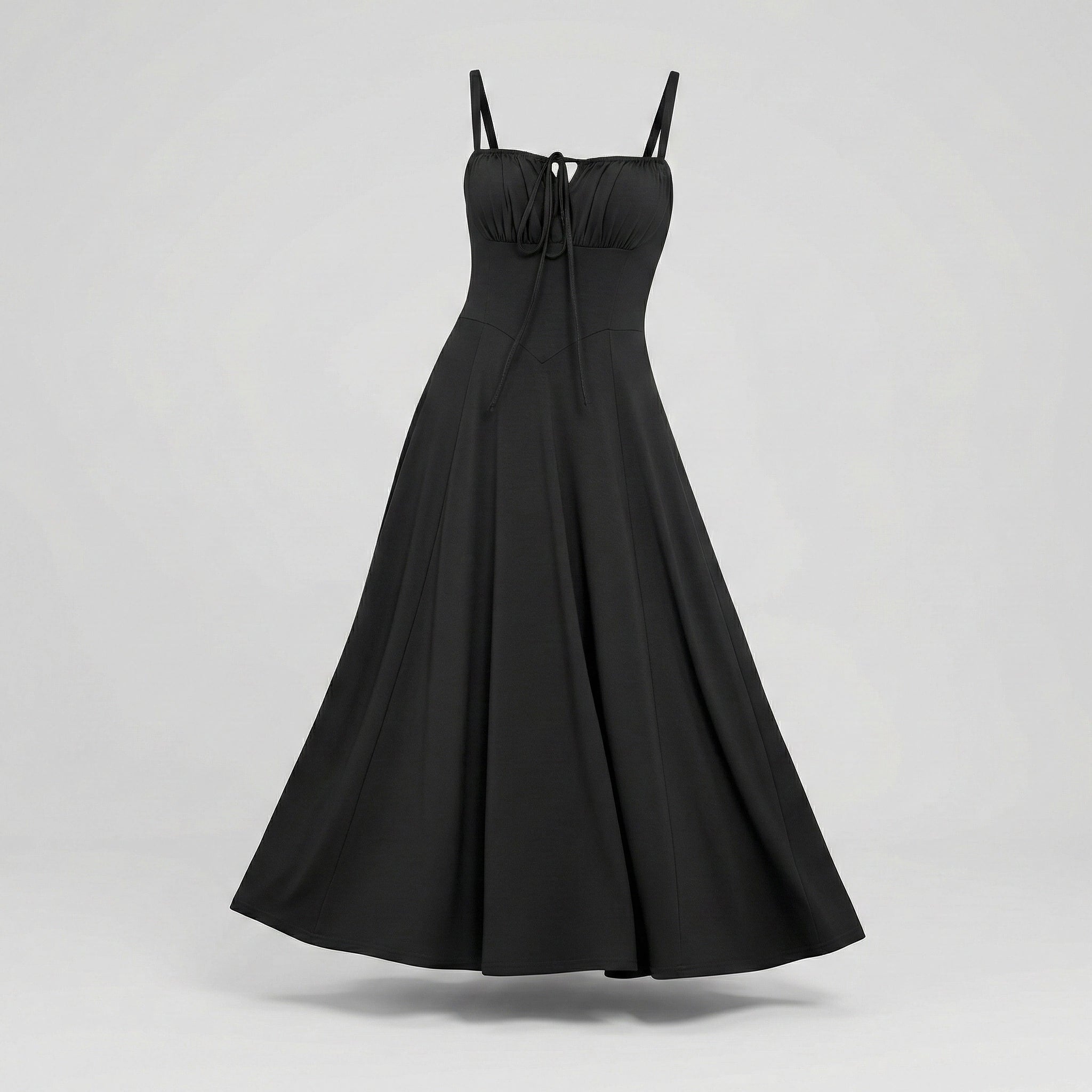 Black dress with thin straps on a light gray background