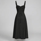 Black dress with thin straps on a gray background