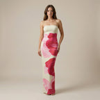 Woman wearing a strapless dress with pink floral pattern on a beige background