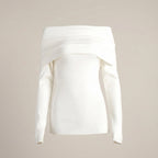 White off-shoulder top on a beige background