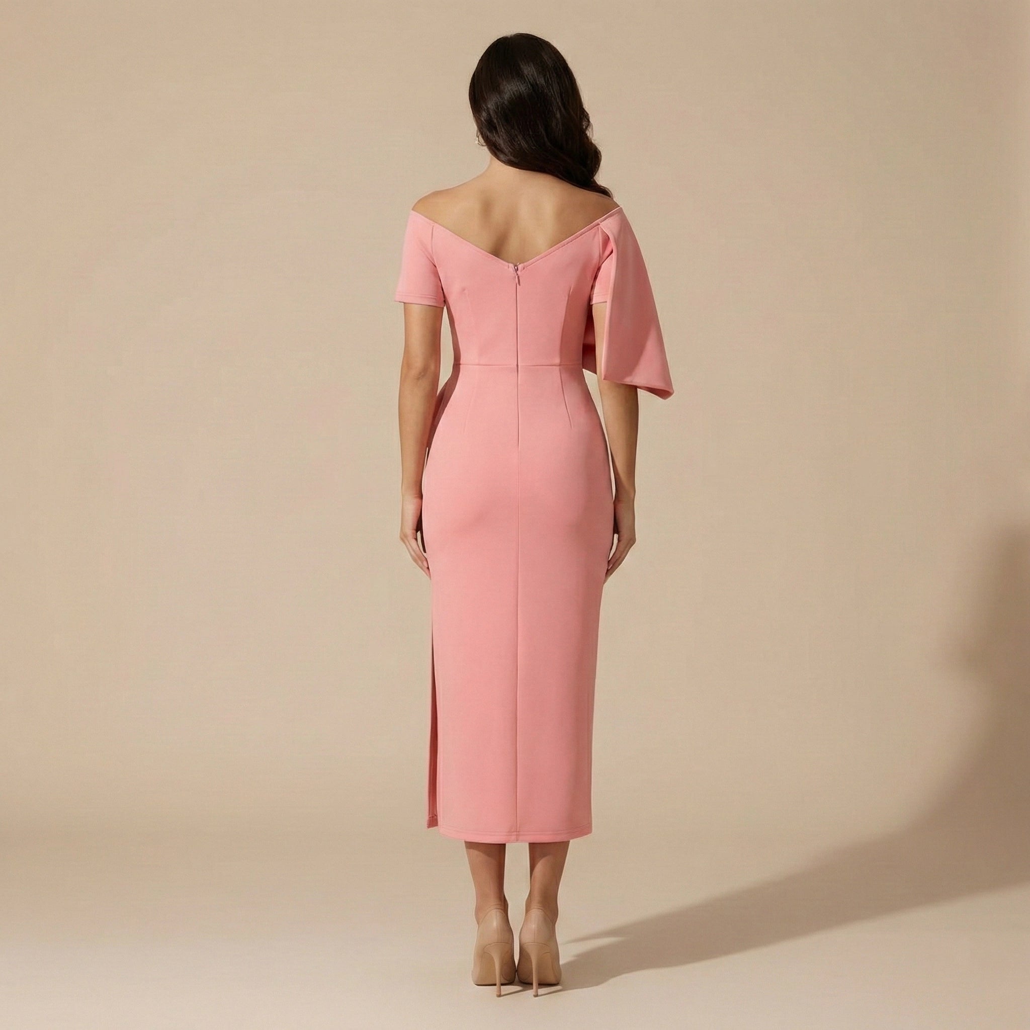 Pink off-shoulder dress worn by a model on a beige background