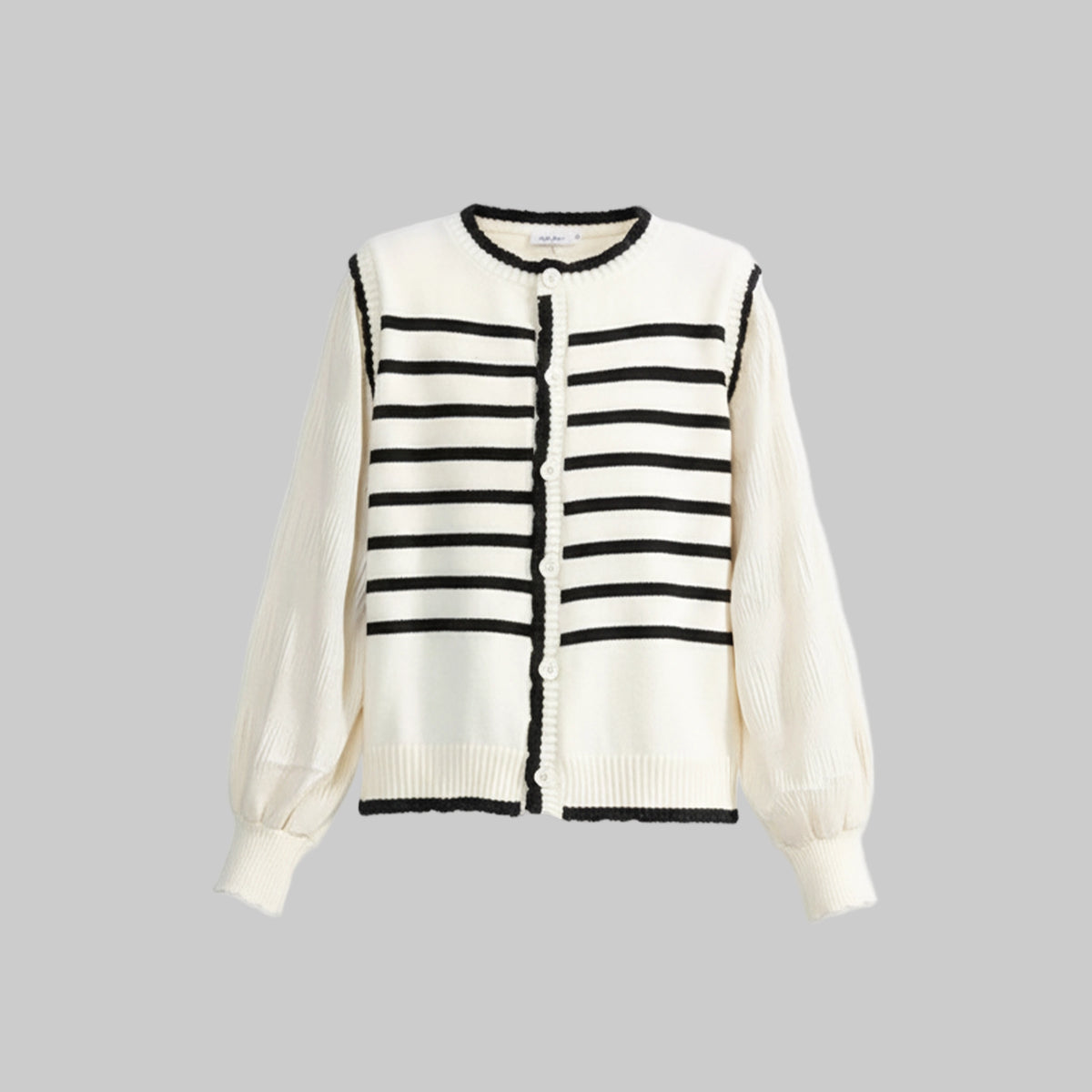 White cardigan with black striped pattern on a light gray background