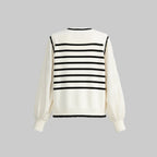 White sweater with black horizontal stripes on a light gray background