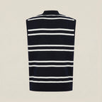 Black and white striped sleeveless sweater on a beige background
