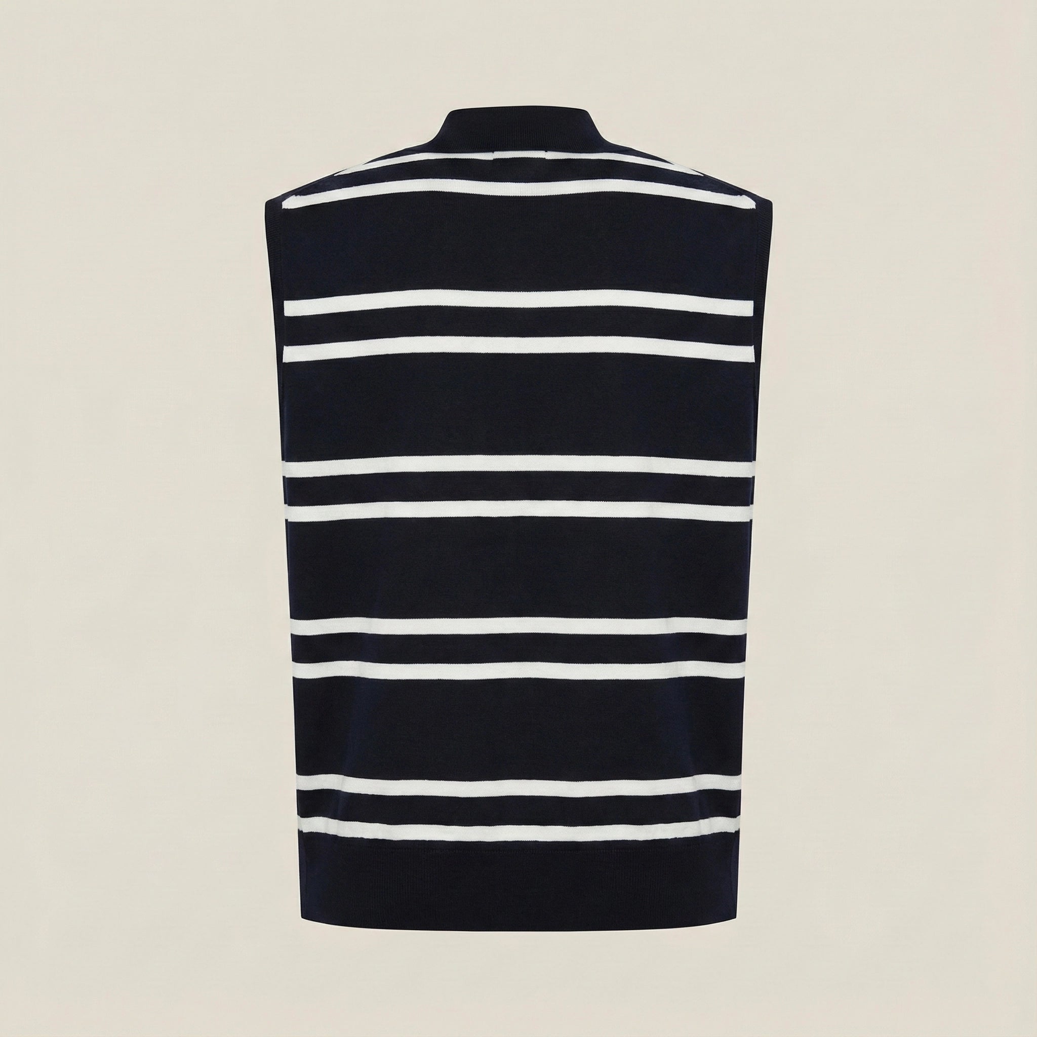 Black and white striped sleeveless sweater on a beige background