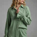 Green textured shirt worn by a person on a gray background