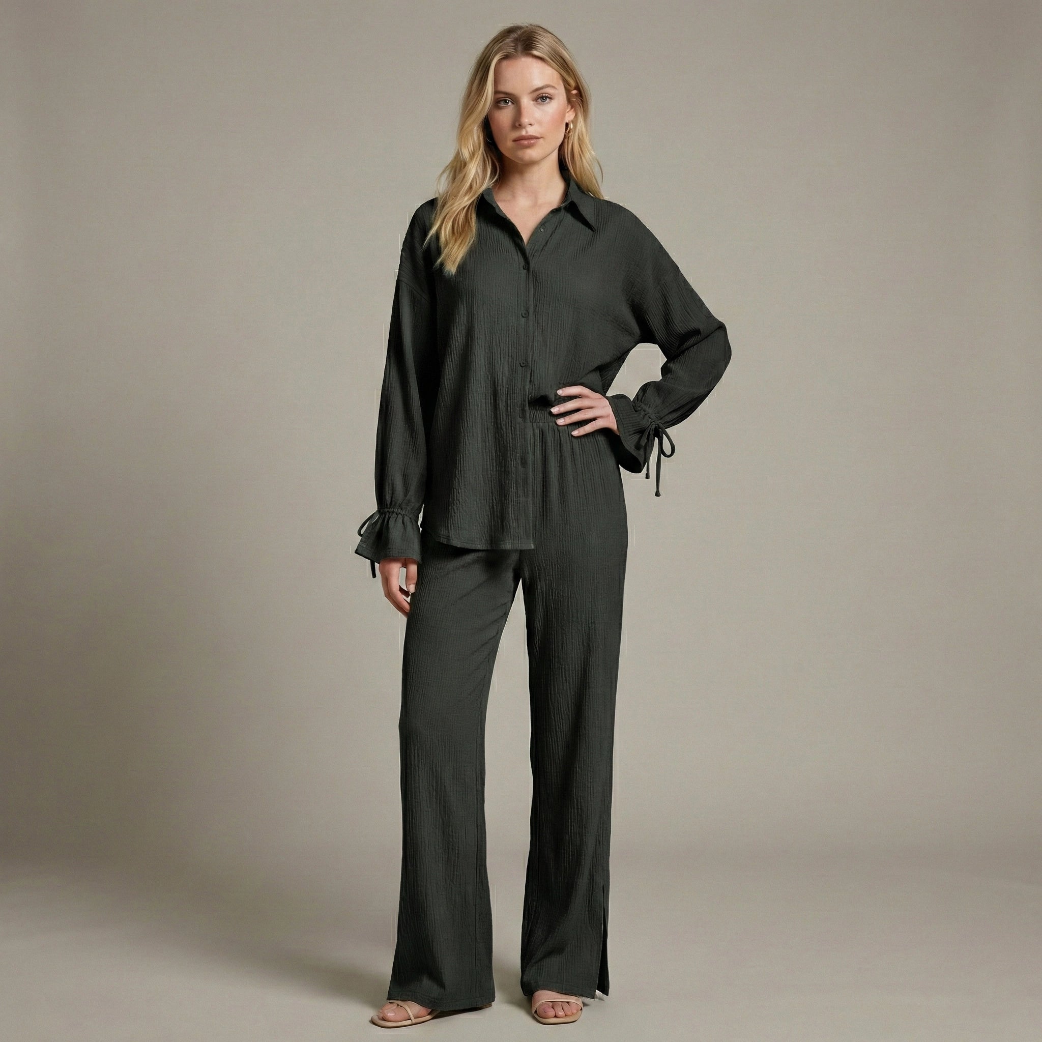 Woman wearing a black outfit against a neutral background