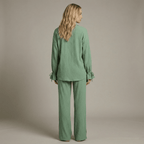 Woman wearing a green outfit against a neutral background