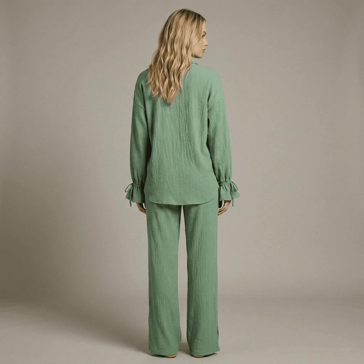 Woman wearing a green outfit against a neutral background