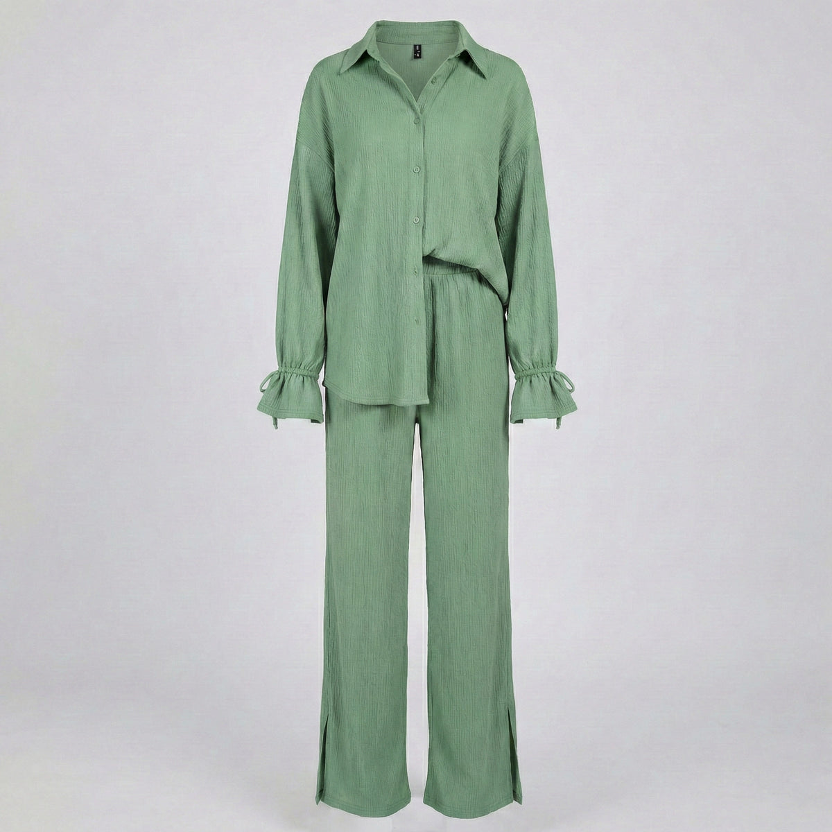 Green outfit with a shirt and pants on a white background