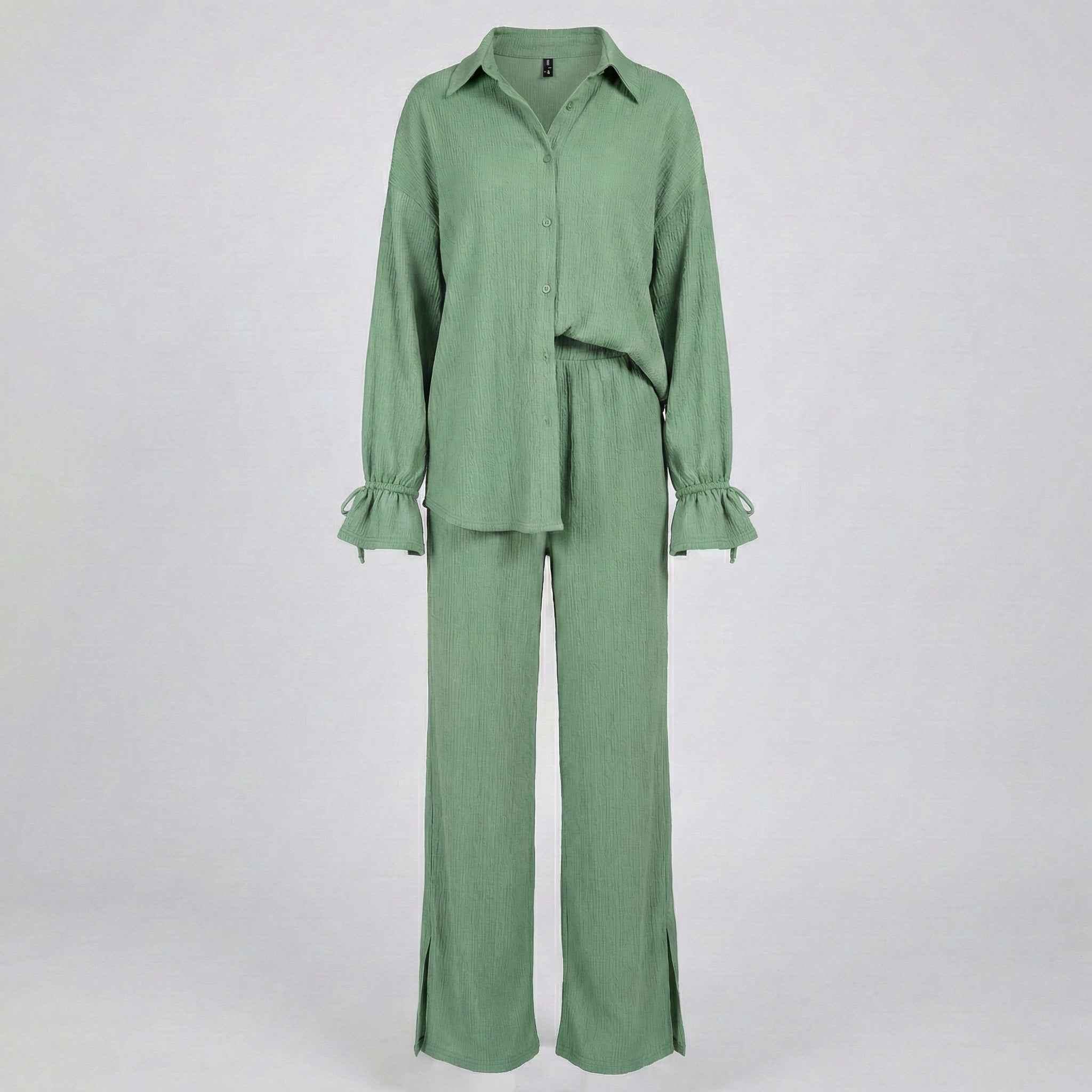 Green outfit with a shirt and pants on a white background