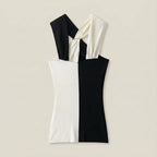 Black and white dress with a knot detail on a beige background