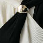Black scarf with a gold tie knot against a white background