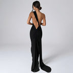Black evening gown with open back on a white background