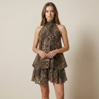 Woman wearing a leopard print dress against a beige background