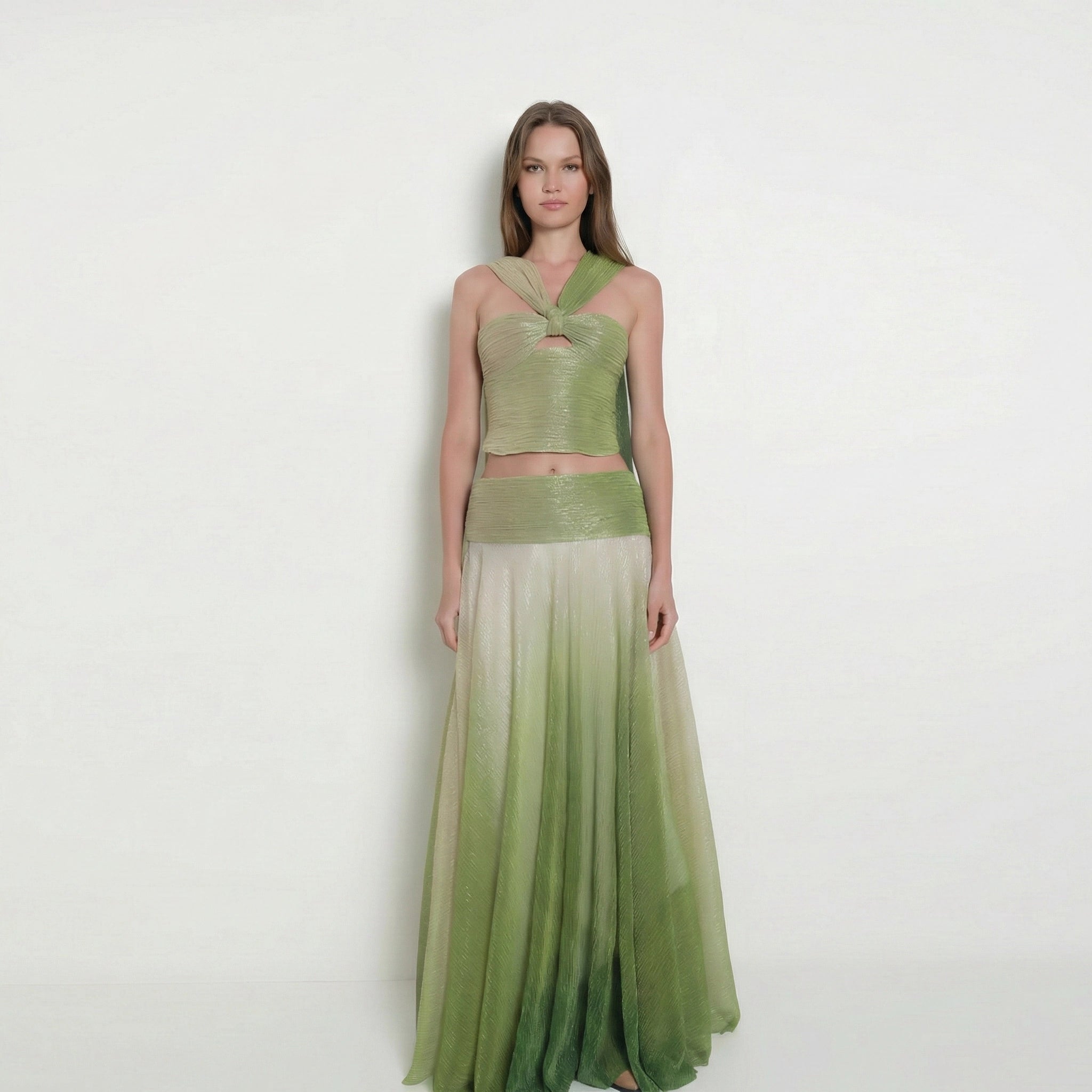 Woman wearing a green dress with a gradient effect on a white background