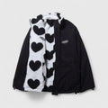 Black jacket with a heart-patterned scarf on a light gray background
