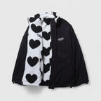 Black jacket with a heart-patterned scarf on a light gray background
