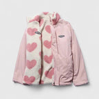 Pink jacket with heart-patterned scarf on a light gray background