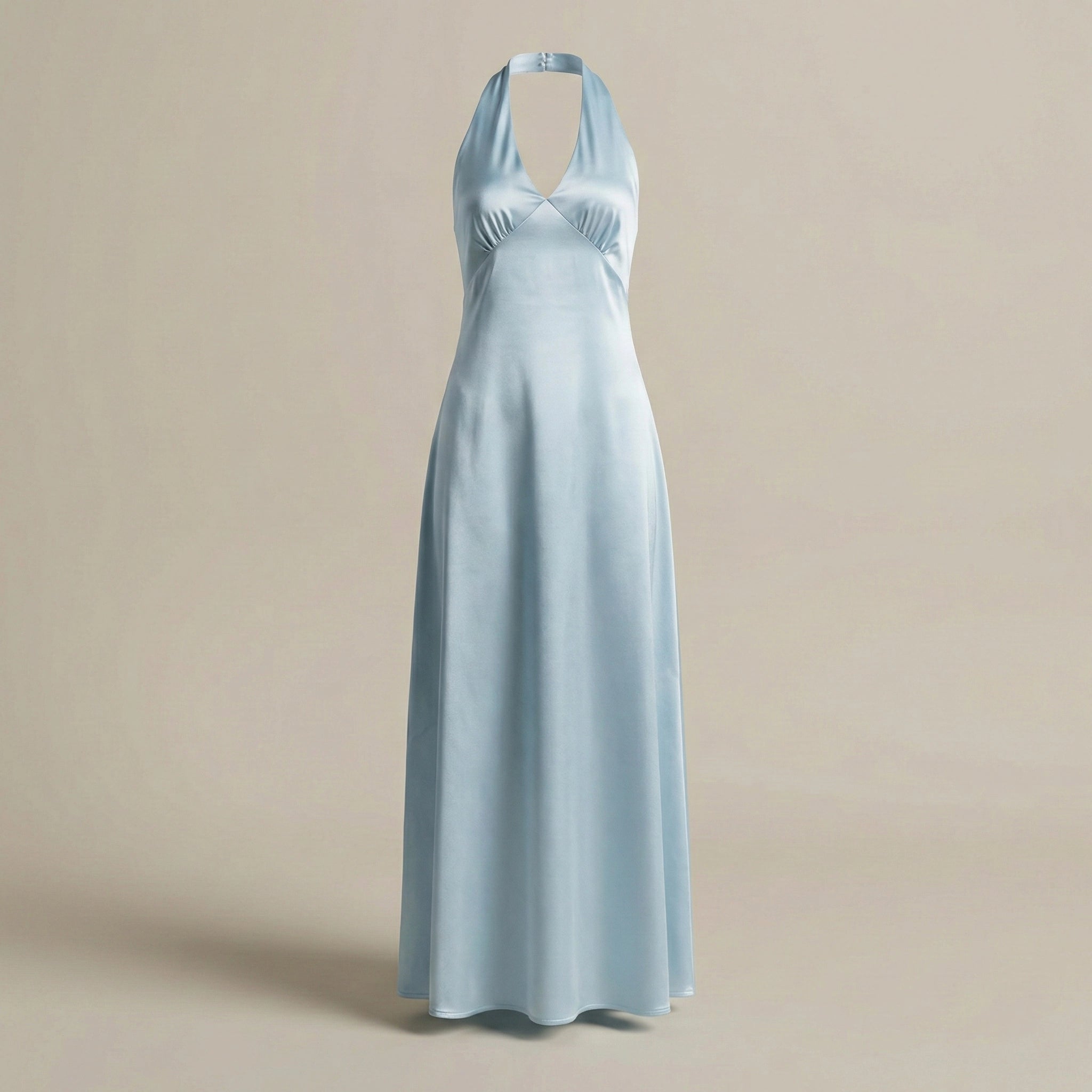 Light blue halter neck dress on a beige background